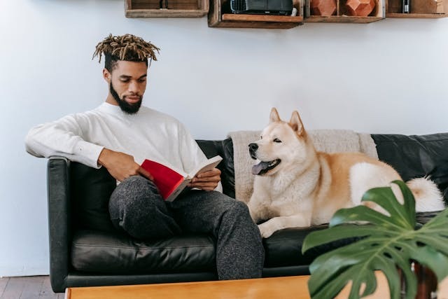Man sitting on couch with dog