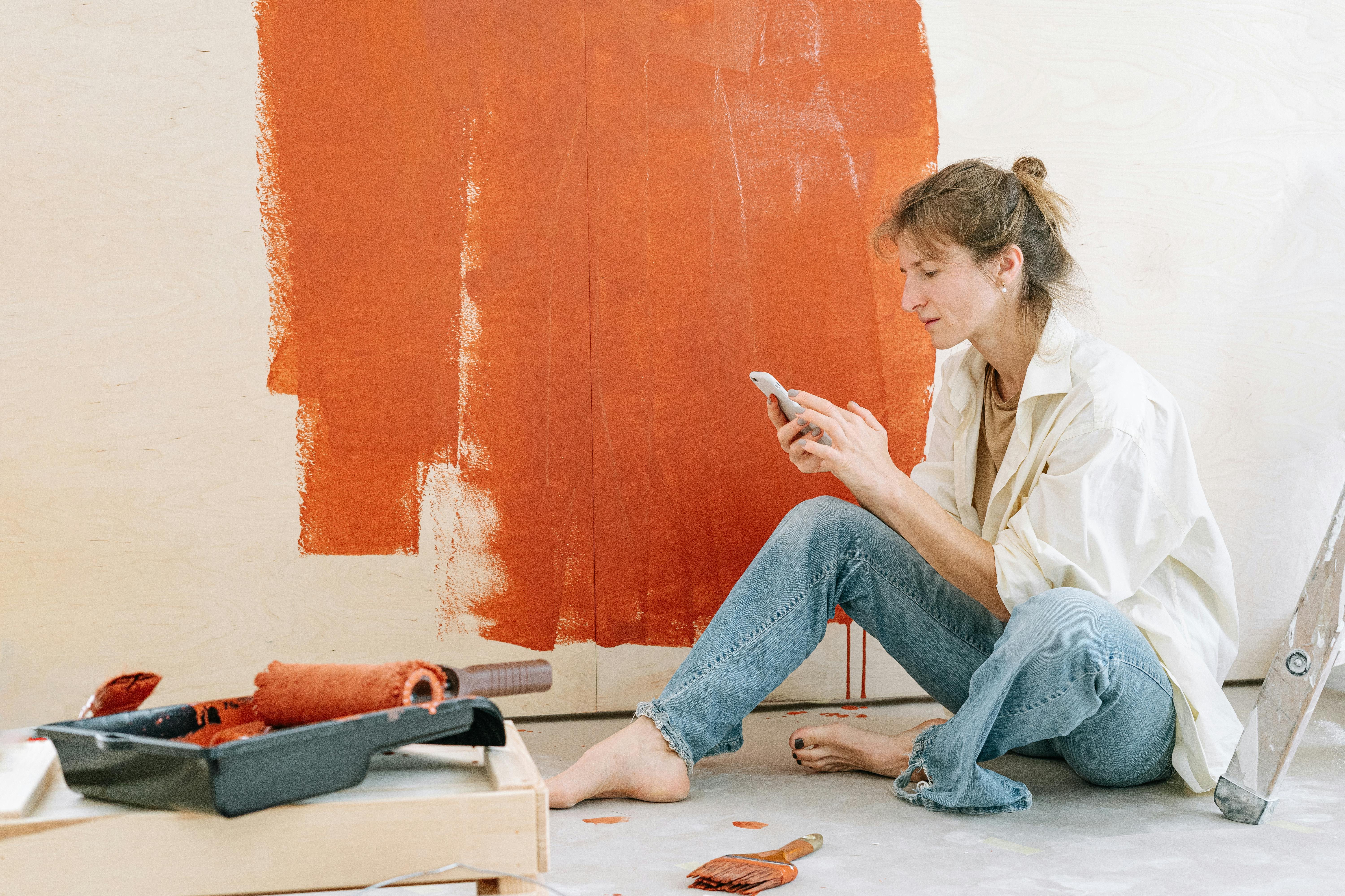 someone painting wall orange
